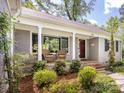 Charming front porch with brick facade and stylish decor at 1310 Woodland Dr, Charlotte, NC 28205