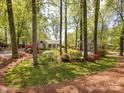 Well landscaped front yard with azaleas and mature trees at 1310 Woodland Dr, Charlotte, NC 28205