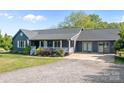 An inviting single-story home featuring a landscaped front yard and a gravel driveway at 139 Fort Dobbs Rd, Statesville, NC 28625