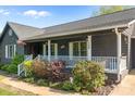 Inviting front porch with white railing, plants and shrubbery at 139 Fort Dobbs Rd, Statesville, NC 28625