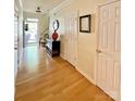 Open foyer featuring hardwood floors, decorative accents, and views of the front door and hallway at 14022 Drake Watch Ln, Charlotte, NC 28262