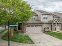 Inviting townhome with a stone facade, two-car garage, and well-manicured lawn on Cramer Place Court at 2001 Cramer Place Ct, Cramerton, NC 28032