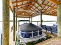 Waterfront boat dock with boat lift and seating area at 2045 Manila Bay Ln, Tega Cay, SC 29708