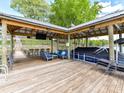 Waterfront dock area includes an outdoor television, seating, and boat lift at 2045 Manila Bay Ln, Tega Cay, SC 29708