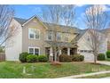 Charming two-story home with mature trees, established bushes and well-maintained lawn at 2065 Taney Way, Indian Land, SC 29707