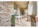 Cozy brick porch with seating and greenery, perfect for relaxing outdoors at 2065 Taney Way, Indian Land, SC 29707