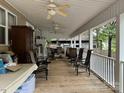 Spacious covered porch featuring multiple seating areas at 207 Deer Park Rd, Mount Gilead, NC 27306