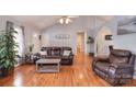 Cozy living room featuring hardwood floors, vaulted ceilings, and comfortable leather furniture at 216 Dewars Dr, Rock Hill, SC 29730