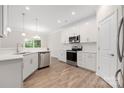 Modern kitchen featuring stainless steel appliances, white cabinets, and sleek countertops at 23112 Clarabelle Dr, Charlotte, NC 28273