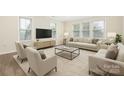 Bright living room with neutral furnishings, abundant natural light, and hardwood floors at 23112 Clarabelle Dr, Charlotte, NC 28273