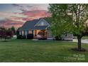 Charming home with well-kept lawn and inviting entry, framed by a picturesque sunset at 234 Deal Estate Dr, China Grove, NC 28023