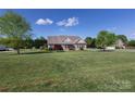 Beautifully landscaped home on a spacious lot with mature trees and well-maintained lawn at 234 Deal Estate Dr, China Grove, NC 28023