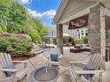 Inviting outdoor space featuring a pool, fire pit, and cozy seating, perfect for relaxing and entertaining at 2553 Fallbrook Nw Pl, Concord, NC 28027