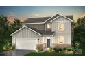 Two-story home featuring neutral siding, a two-car garage, and a welcoming front porch at 2573 Blue Sky Meadows Dr, Monroe, NC 28110