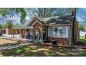 Quaint brick home boasting a covered front porch and well-maintained landscaping at 2701 N Main Ave, Newton, NC 28658
