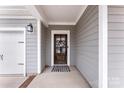 Close up of Front Door with wreath, siding, and hardware details at 3041 Winged Teal Ct, Belmont, NC 28012