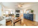 Inviting living room featuring hardwood floors, a fireplace, and stylish decor at 3510 Conway Ave, Charlotte, NC 28209