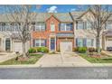 Charming brick townhome featuring a one-car garage, well-maintained landscaping, and a welcoming front entrance at 4011 Fenworth Ct, Fort Mill, SC 29715