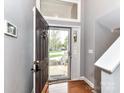 Bright foyer showcasing wood floors and a storm door with lots of natural light at 4743 Morning Dew Ct # 4743, Charlotte, NC 28269