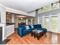 Open concept living room and dining room with a cozy blue velvet sofa at 4743 Morning Dew Ct # 4743, Charlotte, NC 28269