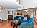 Cozy living room featuring a fireplace, wood floors, and an open layout at 4743 Morning Dew Ct # 4743, Charlotte, NC 28269