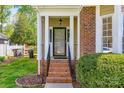 Inviting front door entrance with brick steps, white pillars, and manicured landscaping for curb appeal at 609 Tysons Forest Dr, Rock Hill, SC 29732