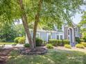 Beautiful home exterior with mature landscaping surrounding the front yard at 6123 Glen Manor Dr, Charlotte, NC 28269