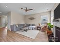 Comfortable living room with a ceiling fan, large gray couch, and hardwood floors at 637 Amber Meadows Way, Fort Mill, SC 29708
