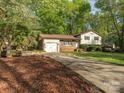 Split-level home featuring a large driveway and brick accents at 7024 Rockledge Dr, Charlotte, NC 28210