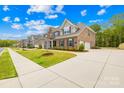 Brick home showcasing a long driveway and manicured lawn at 705 Brown Creek Dr, Matthews, NC 28104