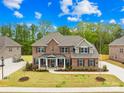 Spacious brick home featuring a well-maintained lawn and mature landscaping at 705 Brown Creek Dr, Matthews, NC 28104