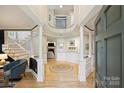 Bright foyer featuring hardwood floors, white columns, and open access to the living spaces at 7117 Chadwyck Farms Dr, Charlotte, NC 28226