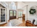 Grand foyer with a soaring window, hardwood floors, and a view to the dining area at 7316 Versailles Ln, Charlotte, NC 28277