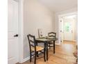 Cozy dining area with a black table and chairs, wood flooring, and a view of the backyard through a doorway at 803 E 13Th St, Kannapolis, NC 28083
