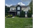 Charming two-story home with manicured lawn and vibrant landscaping, offering inviting curb appeal at 8140 Laurel Run Dr, Charlotte, NC 28269