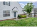 Home exterior featuring a well-maintained lawn, trimmed bushes, and welcoming front door at 942 Pelican Bay Dr, Pineville, NC 28134