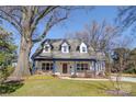 Charming home with large front porch and dormer windows, set against a clear blue sky at 1009 Leigh Ave, Charlotte, NC 28205