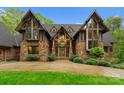 Detailed exterior view of a stone and timber home, highlighting the architectural design and landscaping at 10723 Green Heron Ct, Charlotte, NC 28278