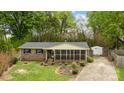 Aerial view of charming brick home with a screened-in back porch and a long driveway at 1113 Urban Pl, Charlotte, NC 28209