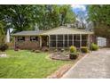 Charming brick home with a screened-in front porch and long driveway at 1113 Urban Pl, Charlotte, NC 28209