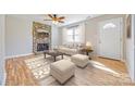 Inviting living room with a stone fireplace, light hardwood floors, and bright natural light at 1153 Doris Ct, Rock Hill, SC 29730