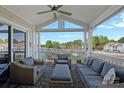 Inviting covered porch featuring comfortable seating and a picturesque lake view at 1211 Torrence Cir, Davidson, NC 28036