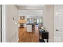 Open-concept living area with modern kitchen, hardwood floors, and lake views at 1211 Torrence Cir, Davidson, NC 28036