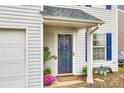 Close up of front door, potted plants, small bench, painted siding, and covered stoop at 1581 Arborgate Dr, Rock Hill, SC 29732