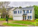 View of a two-story home with white siding, blue shutters, green lawn, and driveway at 1581 Arborgate Dr, Rock Hill, SC 29732