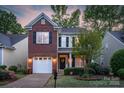 Beautiful two-story home featuring a brick accent wall, attached garage, and manicured front lawn at 16524 Kettlewell Ln, Charlotte, NC 28277