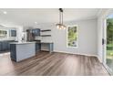 Open dining area boasts an island, and stylish light fixture above the table at 1676 Starmount Cir, Lancaster, SC 29720