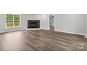 Bright living room featuring a cozy brick fireplace and hardwood floors at 1676 Starmount Cir, Lancaster, SC 29720