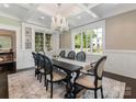Elegant dining room featuring a coffered ceiling, large windows, and a stylish chandelier at 2030 Radcliffe Ave, Charlotte, NC 28207
