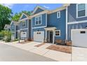 Attractive townhome complex in blue and white with a one-car garage at 2032 Summey Ave, Charlotte, NC 28205